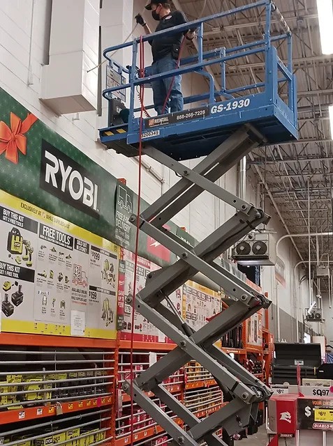 Commercial air duct cleaner on a scissor lift